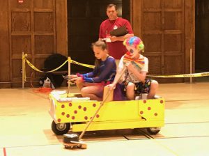 students in costume in their skit vehicle