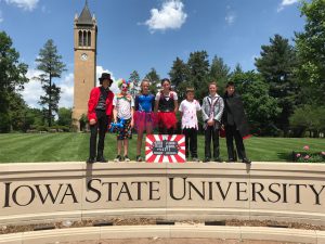 students by Iowa State University sign