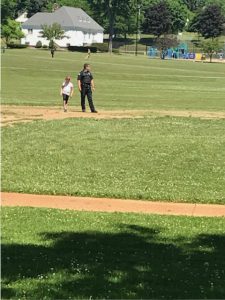 officer on field with student