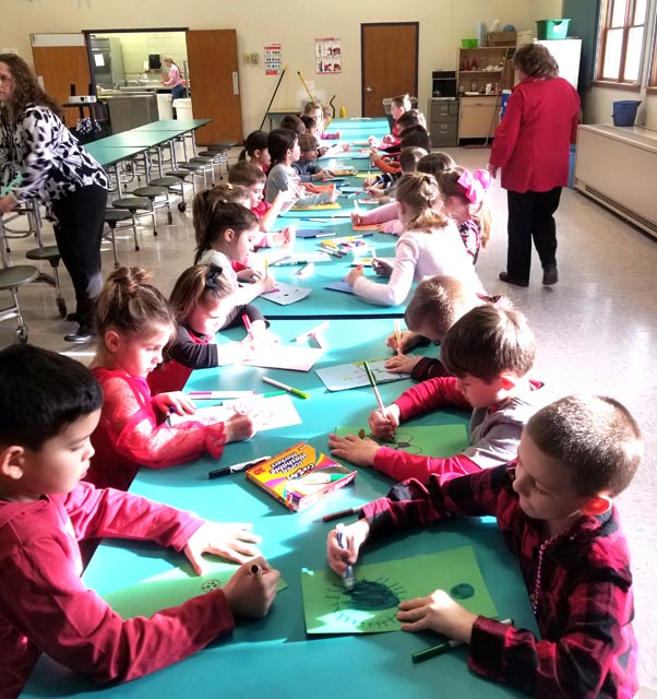 kids at cafeteria tables working on craft project