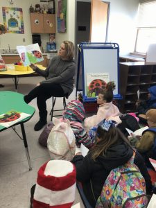 a guest reader sharing a story with students