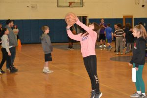 another student aims for the basket