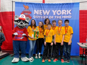 students wearing second place medals pose with Odyssey mascot