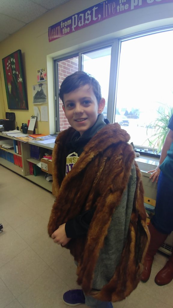 student draped in a fur pelt