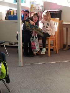 adult and child reading in library