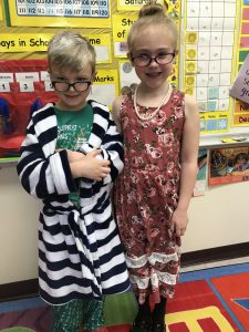 two students wearing glasses and dress up clothes