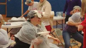 another staff member with a pie in the face
