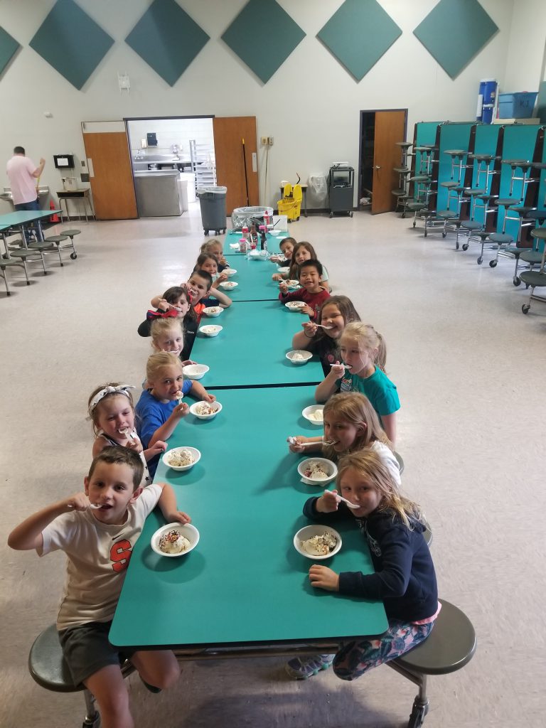 group shot of children at cafeteria tables
