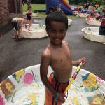 boy standing in kiddie pool