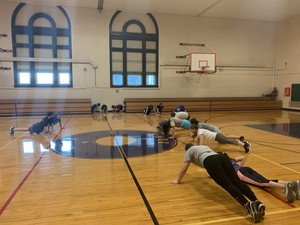 fourth group of Knox students doing push ups