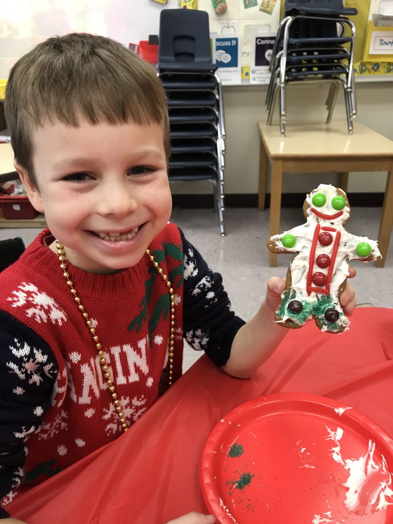 third student with decorated cookie
