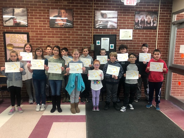 group photo of Students of the Month in Warren Street lobby