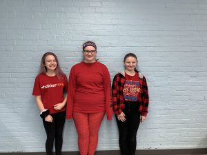three students dressed in red