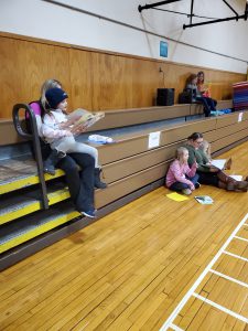 families reading in the gym