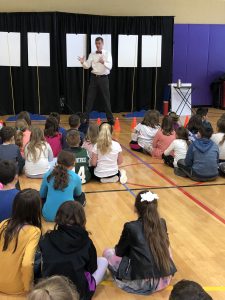 presenter addressing students in the gym