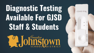a graphic of a hand in a surgical glove, holding a COVID test, is next to text reading "Diagnostic Testing Available For GJS Staff & Students", along a with the Johnstown logo