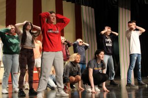 students practice choreography on a theatrical stage