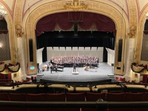 a symphony band plays on a theater stage