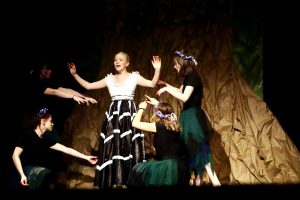 young female actors are shown on a theatrical stage