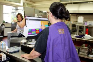 a woman uses a cash register