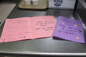 a hand written thank you card on pink and purple construction paper