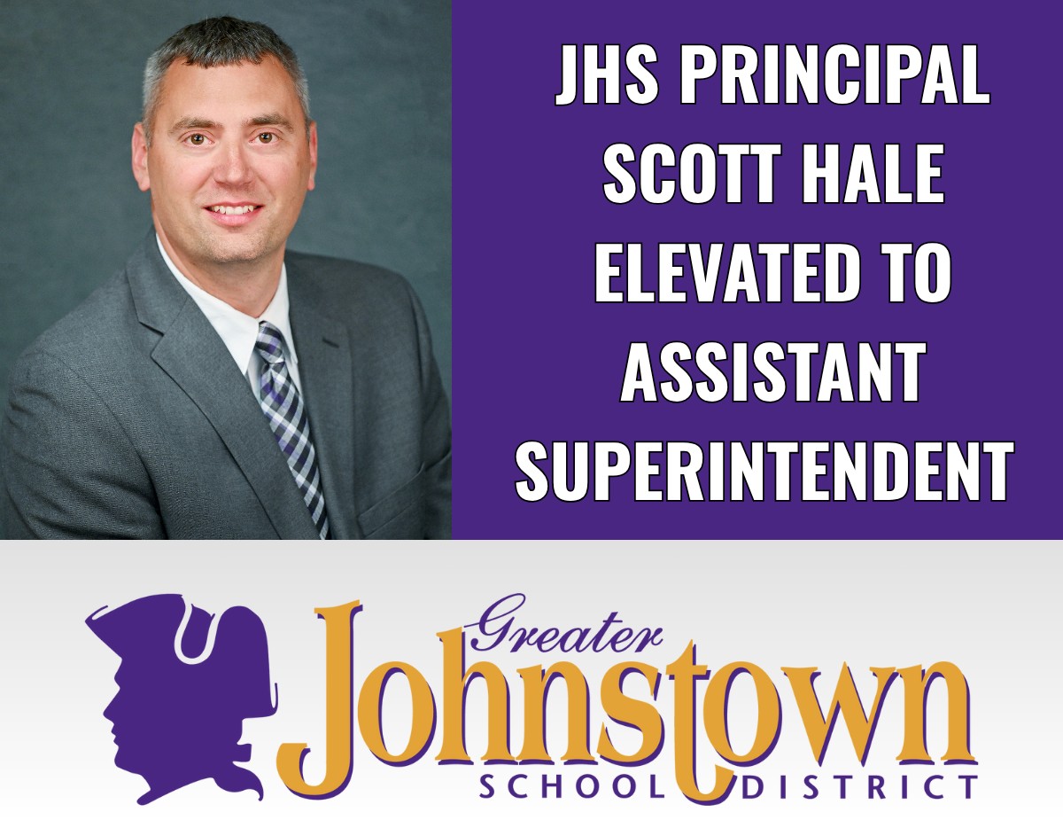 a man wearing a grey suit poses, along with a graphic that reads "JHS Principal Scott Hale elevated to Assistant Superintendent"