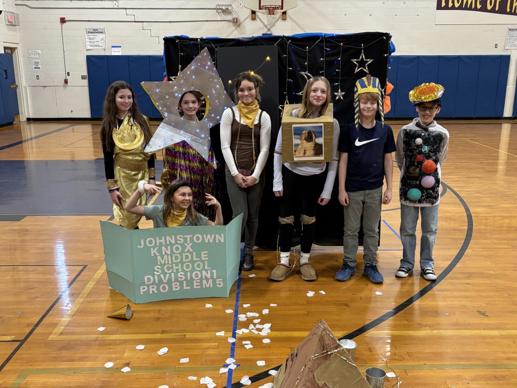 seven middle school students dress up in costume to perform a skit