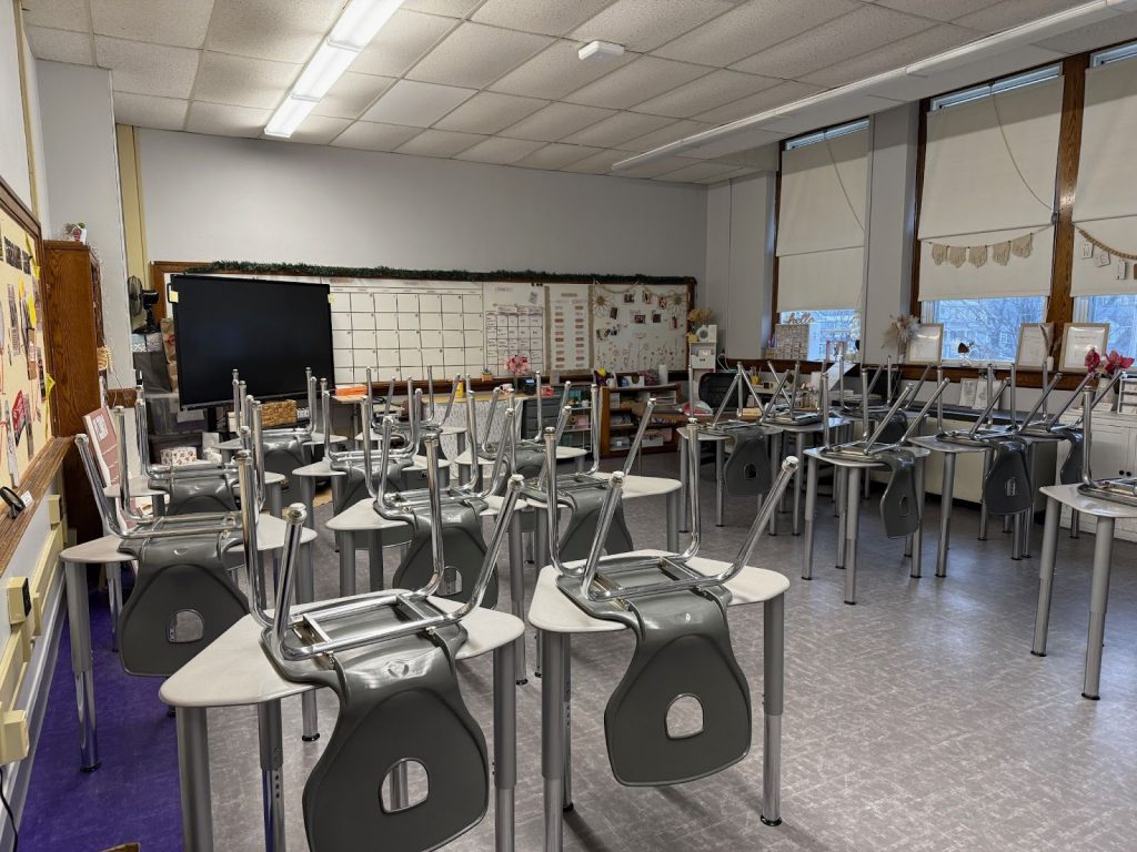 a classroom with tables upside down on desktops