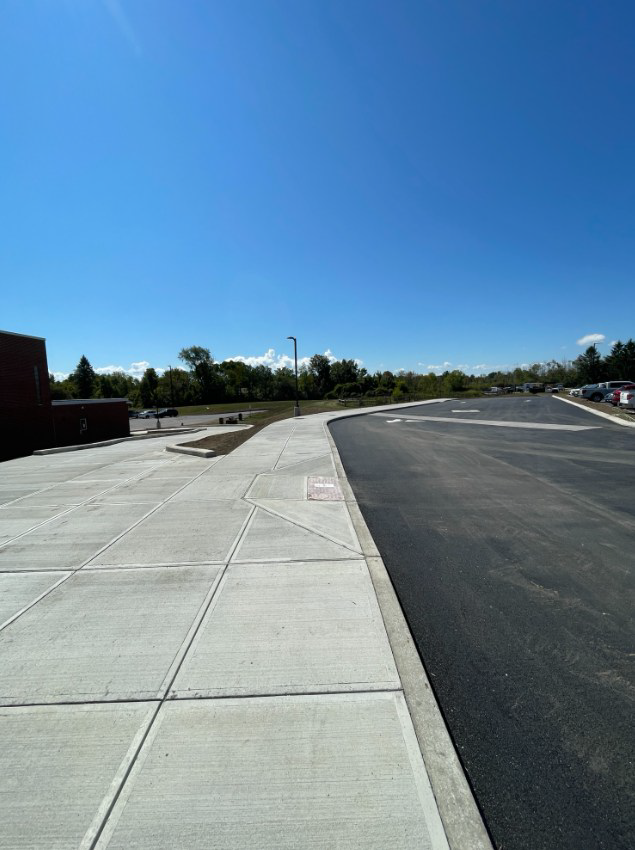 a newly constructed bus loop shows new pavement, curbs and sidewalks