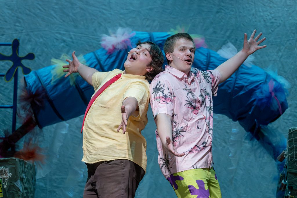 two young teen actors perform a duet on stage