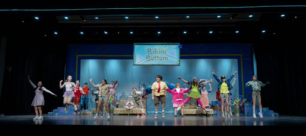 student actors play out a scene on stage