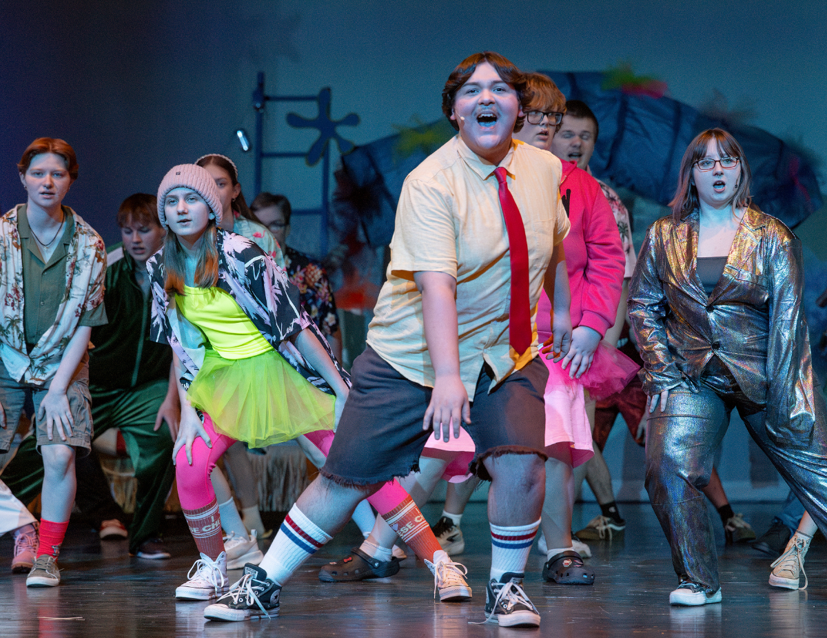 the cast to a play performs on stage