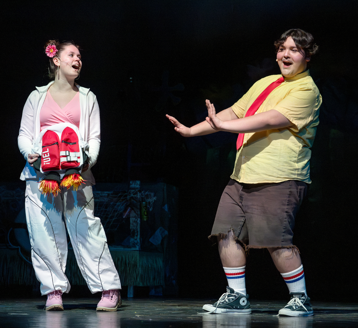 two actors perform on a theatrical stage